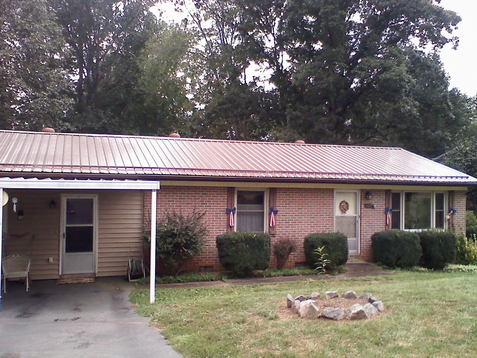 Bronze metal roof and carport on a brick ranch home — Roof Repair work by our crew in Woodbury